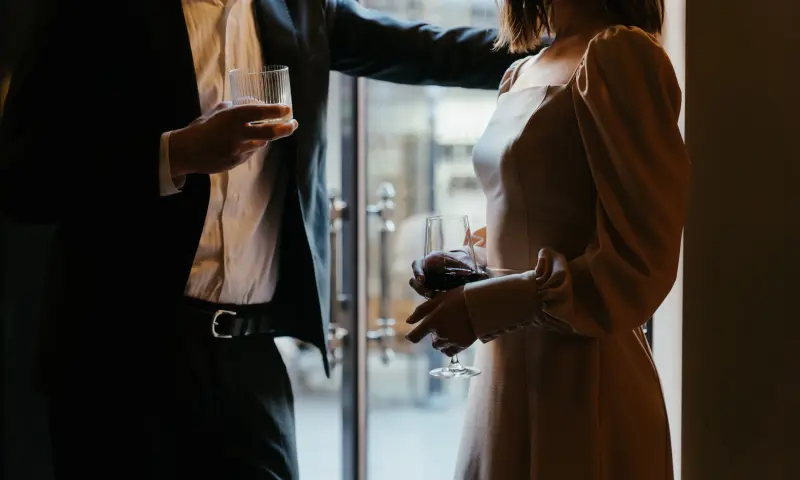 man en vrouw staan met wijn